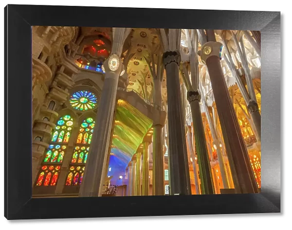 La Sagrada Familia church, basilica interior with stained glass windows by Antoni Gaudi