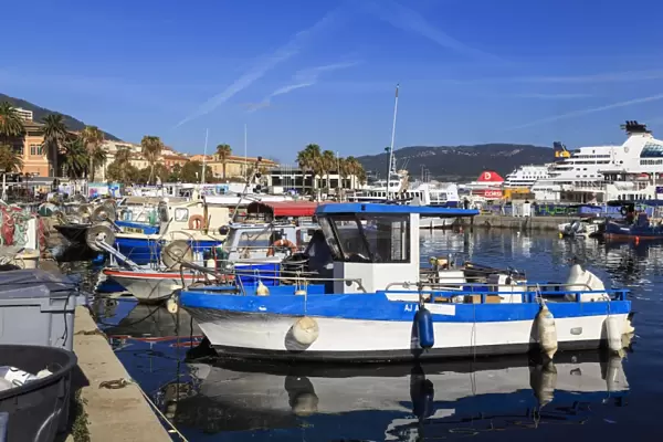 Old Port with fishing boats, cruise ship and ferries, view to distant mountains, Ajaccio