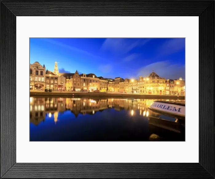 Framed Print : Dusk lights up typical houses reflected in a canal of the River Spaarne, Haarlem