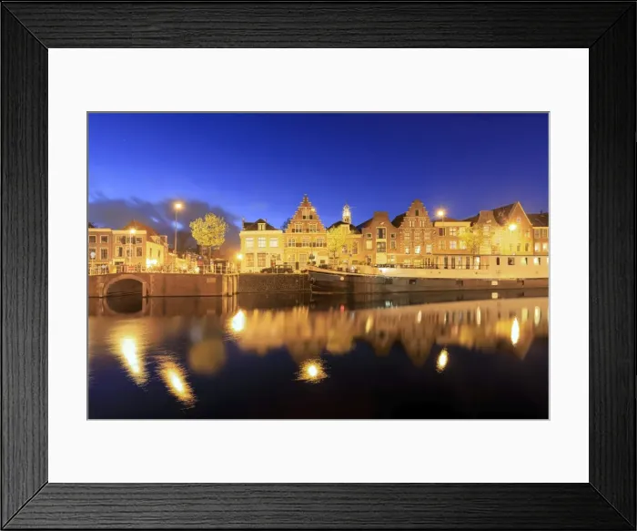 Framed Print : Dusk lights on typical houses and bridge reflected in a canal of the River Spaarne Framed Print : Dusk lights on typical houses and bridge reflected in a canal of the River Spaarne
