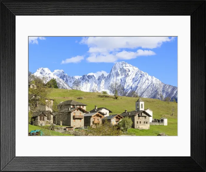 Framed Print : Alpine village and meadows framed by the snowy peak of Pizzo di Prata, Daloo, Chiavenna Valley
