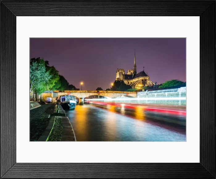 Framed Print : Long exposure of a boat on the River Seine passing Notre Dame Cathedral on a wet evening in Paris Framed Print : Long exposure of a boat on the River Seine passing Notre Dame Cathedral on a wet evening in Paris