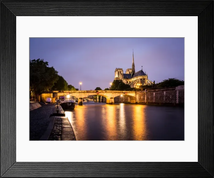 Framed Print : Notre Dame Cathedral and lights reflecting in the River Seine on a wet evening in Paris Framed Print : Notre Dame Cathedral and lights reflecting in the River Seine on a wet evening in Paris
