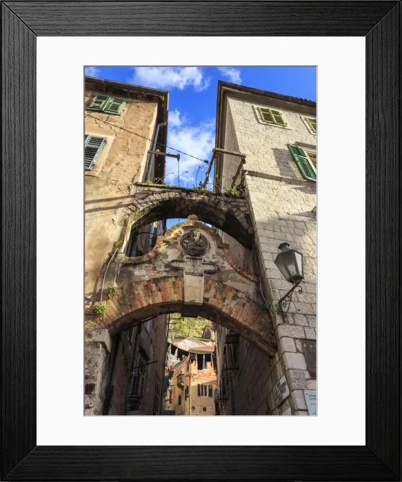 Framed Print : Old Town (Stari Grad), arch way with relief and hanging washing in an alley, Kotor Framed Print : Old Town (Stari Grad), arch way with relief and hanging washing in an alley, Kotor