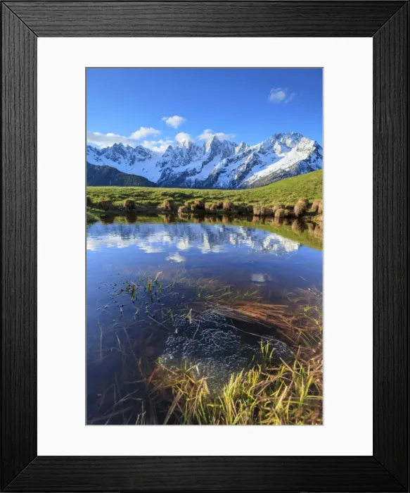 Framed Print : Snowy peaks and blue sky reflected in water at dawn, Tombal, Soglio, Bregaglia Valley