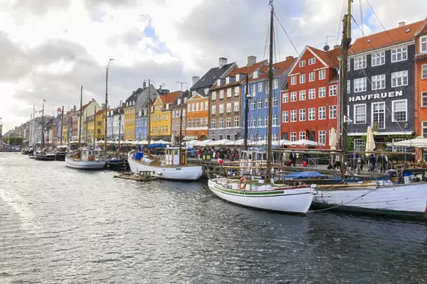 Colourful facades and typical boats along the canal and entertainment district of Nyhavn