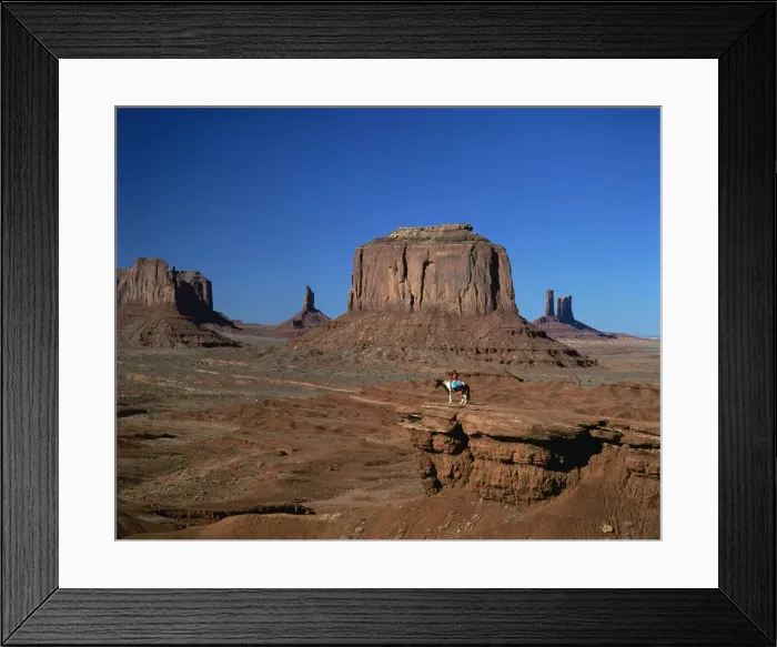 Framed Print : A woman on horseback in the desert with rock formations Framed Print : A woman on horseback in the desert with rock formations