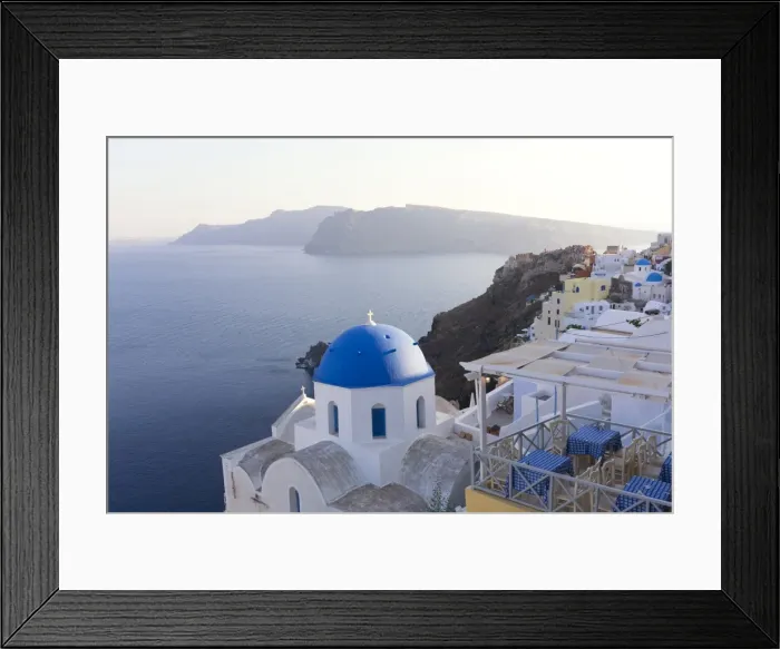 Framed Print : Evening view over the Caldera from Oia with blue domed church and distant volcanic cliffs Framed Print : Evening view over the Caldera from Oia with blue domed church and distant volcanic cliffs
