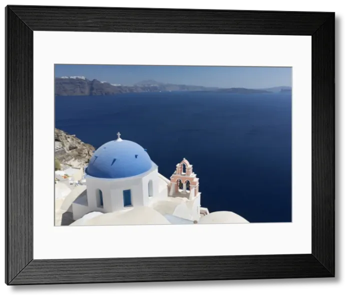 Framed Print : Classic view over the Caldera showing blue domed church and pink belltower, Oia, Santorini Framed Print : Classic view over the Caldera showing blue domed church and pink belltower, Oia, Santorini