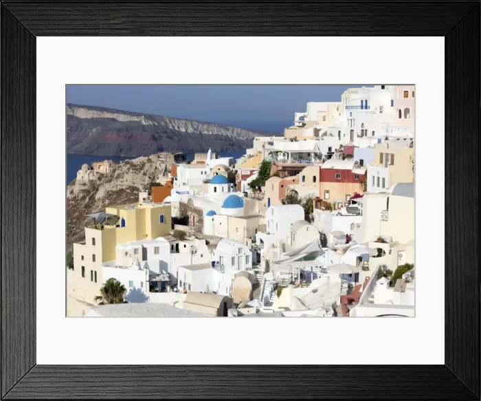 Framed Print : Classic view of the village of Oia with its blue domed churches and colourful houses Framed Print : Classic view of the village of Oia with its blue domed churches and colourful houses