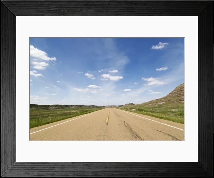 Framed Print : Blue sky over a highway through the Badlands of Alberta, near Drumheller, Alberta Framed Print : Blue sky over a highway through the Badlands of Alberta, near Drumheller, Alberta