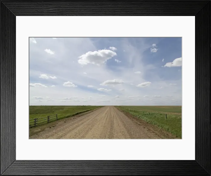 Framed Print : Clouds and blue sky over a dirt track in the Badlands of Alberta, near Drumheller Framed Print : Clouds and blue sky over a dirt track in the Badlands of Alberta, near Drumheller