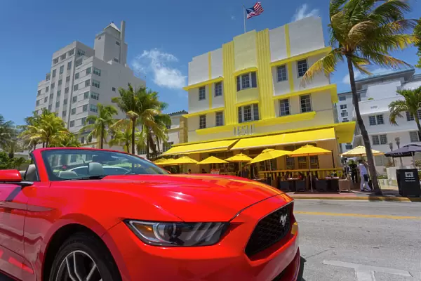 Art Deco architecture and red sports car on Ocean Drive, South Beach, Miami Beach