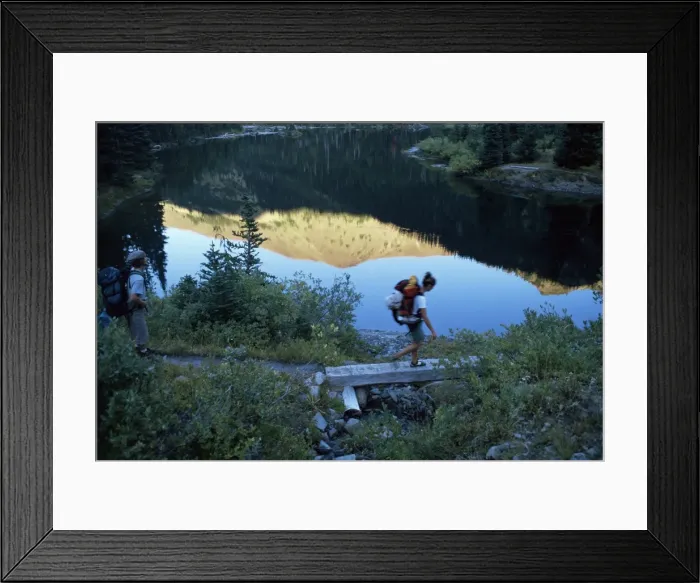 Framed Print : Backpacker crossing bridge Framed Print : Backpacker crossing bridge