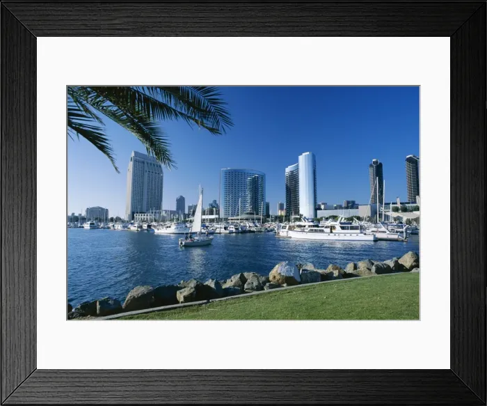 Framed Print : Yacht in front of waterfront skyline seen across Framed Print : Yacht in front of waterfront skyline seen across