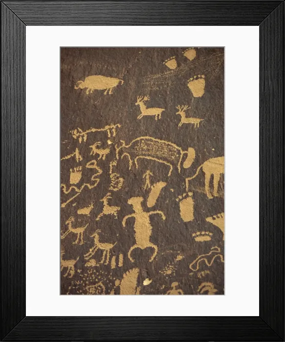 Framed Print : Rock petroglyphs of footprints and animals in the Newspaper Framed Print : Rock petroglyphs of footprints and animals in the Newspaper