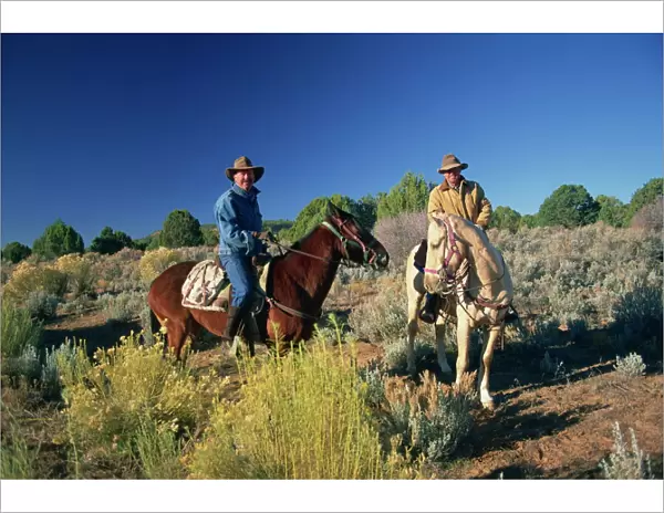 Two cowboys on horseback near Kanab