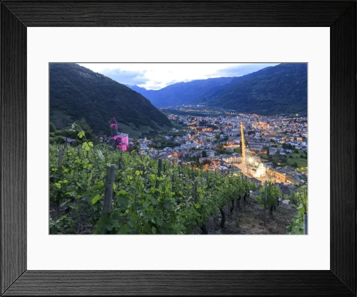 Framed Print : Ancient Xenodochio of Santa Perpetua and the illuminated town of Tirano, province of Sondrio Framed Print : Ancient Xenodochio of Santa Perpetua and the illuminated town of Tirano, province of Sondrio