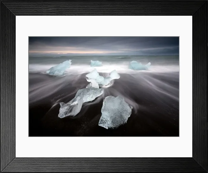Framed Print : Glassy pieces of ice on volcanic black sand beach with blurred waves, near Jokulsarlon Lagoon Framed Print : Glassy pieces of ice on volcanic black sand beach with blurred waves, near Jokulsarlon Lagoon