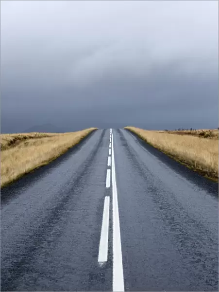 Road stretching away towards stormy sky, Snaefellsnes Peninsula, Iceland, Polar Regions