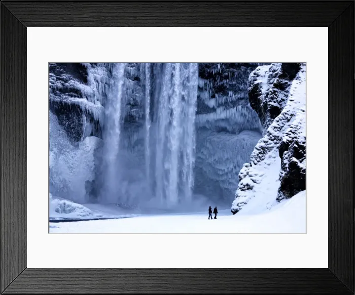 Framed Print : Winter view of Skogafoss waterfall, with cliffs covered in icicles and foregreound covered in snow Framed Print : Winter view of Skogafoss waterfall, with cliffs covered in icicles and foregreound covered in snow