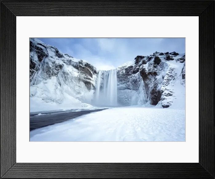 Framed Print : Winter view of Skogafoss waterfall, with cliffs covered in icicles and foregreound covered in snow Framed Print : Winter view of Skogafoss waterfall, with cliffs covered in icicles and foregreound covered in snow