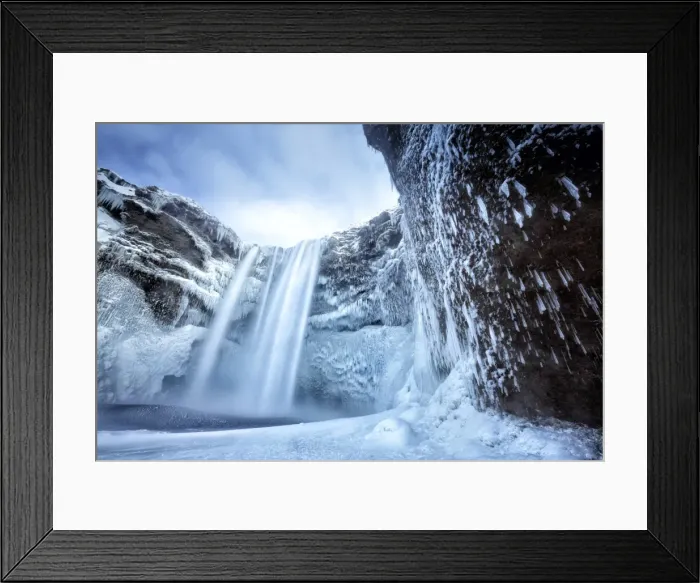 Framed Print : Winter view of Skogafoss waterfall, with cliffs covered in icicles and foregreound covered in snow Framed Print : Winter view of Skogafoss waterfall, with cliffs covered in icicles and foregreound covered in snow
