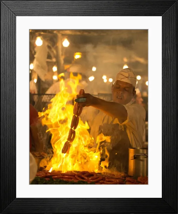 Framed Print : Local man cooking sausages on open flame at one of the food stalls in the Djemaa el Fna Framed Print : Local man cooking sausages on open flame at one of the food stalls in the Djemaa el Fna