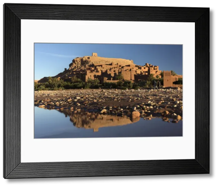 Framed Print : The ancient Kasbah Ait Benhaddou bathed in morning light and reflecting in river Framed Print : The ancient Kasbah Ait Benhaddou bathed in morning light and reflecting in river