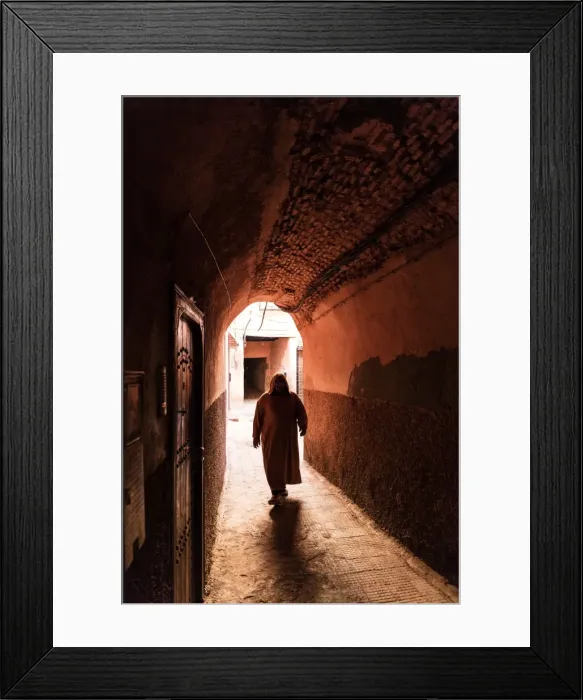 Framed Print : Local man dressed in traditional djellaba walking through archway in a street in the Kasbah Framed Print : Local man dressed in traditional djellaba walking through archway in a street in the Kasbah