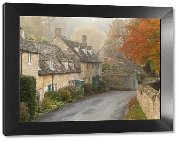 Line of Cotswold stone cottages in autumn mist, Snowshill, Cotswolds, Gloucestershire