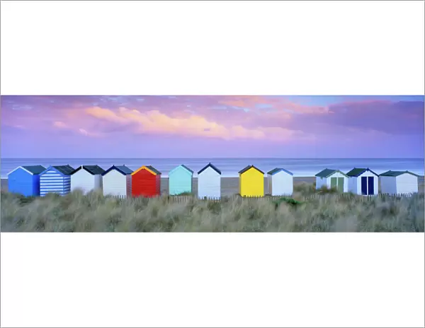Colourful beach huts and sand dunes at sunset, Southwold, Suffolk, England, United Kingdom
