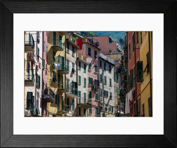 Framed Print : The colourful buildings of Riomaggiores main street in the early morning sunlight Framed Print : The colourful buildings of Riomaggiores main street in the early morning sunlight
