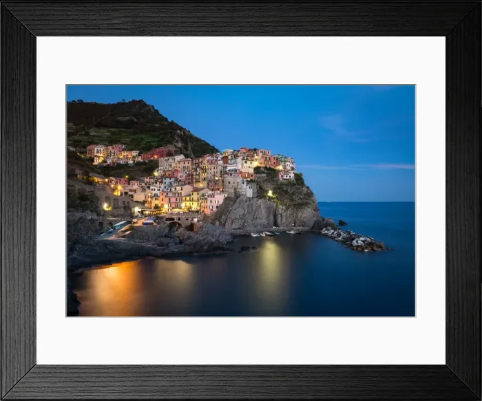 Framed Print : A long exposure at blue hour as the lights come on in the colourful town of Manarola Framed Print : A long exposure at blue hour as the lights come on in the colourful town of Manarola