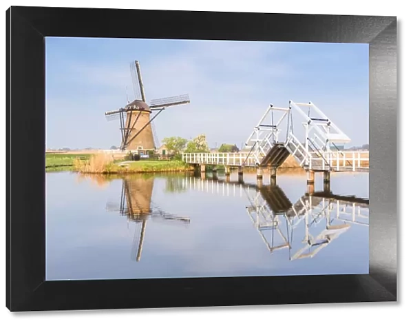 Windmill and sluice on the canal, Kinderdijk, UNESCO World Heritage Site, Molenwaard municipality