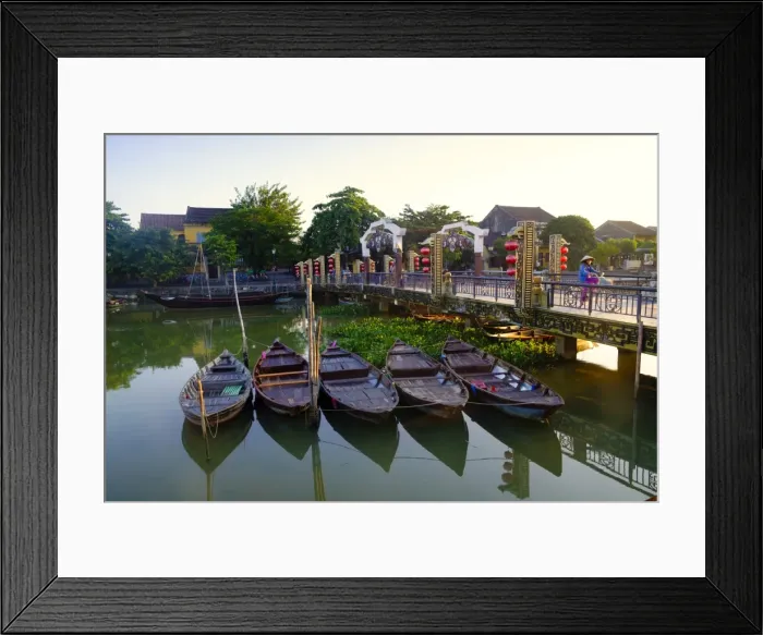 Framed Print : Boats on the Thu Bon River with a cyclist on the Lantern Bridge in Hoi An, UNESCO Framed Print : Boats on the Thu Bon River with a cyclist on the Lantern Bridge in Hoi An, UNESCO