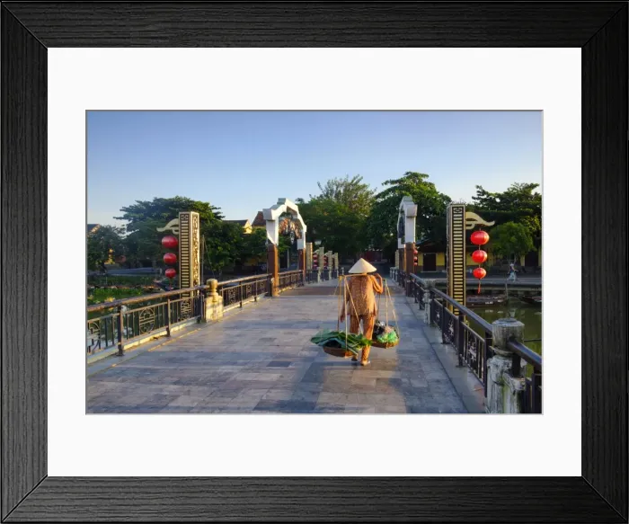 Framed Print : A woman carrying baskets on a yoke over the Lantern Bridge in Hoi An, Quang Nam, Vietnam Framed Print : A woman carrying baskets on a yoke over the Lantern Bridge in Hoi An, Quang Nam, Vietnam