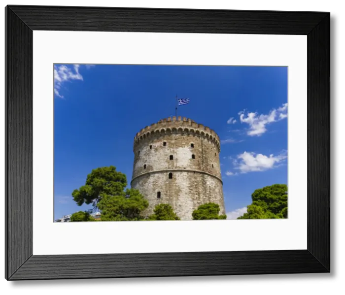 Framed Print : View of the citys landmark The White Tower, with Greek flag waving on top, Thessaloniki Framed Print : View of the citys landmark The White Tower, with Greek flag waving on top, Thessaloniki