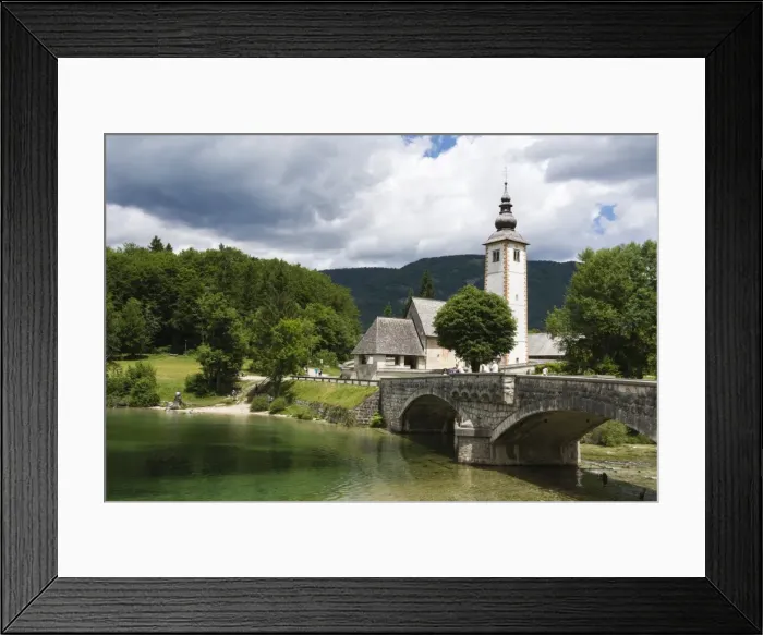 Framed Print : The church of St. John the Baptist and the stone bridge on Lake Bohinj, Slovenia, Europe Framed Print : The church of St. John the Baptist and the stone bridge on Lake Bohinj, Slovenia, Europe