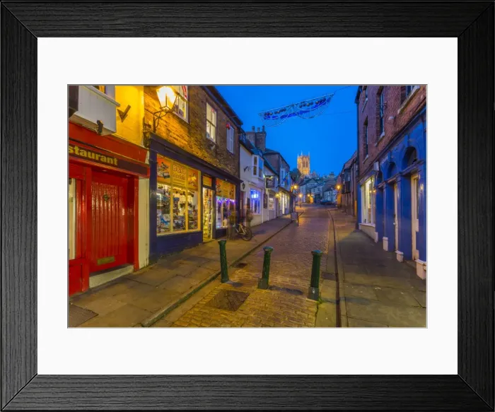 Framed Print : View of illuminated Lincoln Cathedral viewed from the cobbled Steep Hill at dusk Framed Print : View of illuminated Lincoln Cathedral viewed from the cobbled Steep Hill at dusk