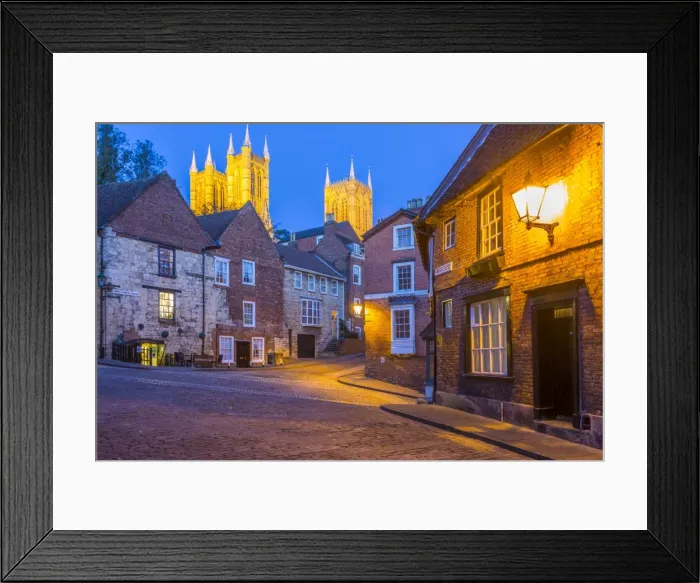 Framed Print : View of illuminated Lincoln Cathedral viewed from the cobbled Steep Hill at dusk Framed Print : View of illuminated Lincoln Cathedral viewed from the cobbled Steep Hill at dusk