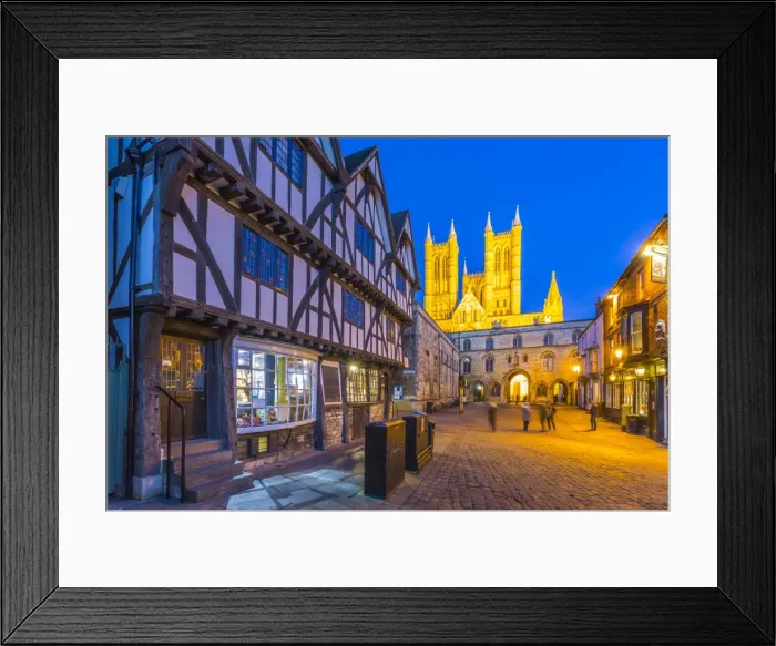 Framed Print : View of illuminated Lincoln Cathedral viewed from Exchequer Gate with timbered architecture Framed Print : View of illuminated Lincoln Cathedral viewed from Exchequer Gate with timbered architecture