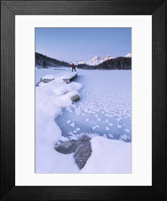Framed Print : Man standing on the shore of frozen lake, Lej da Staz, St. Moritz, Engadine, Canton of Graubunden Framed Print : Man standing on the shore of frozen lake, Lej da Staz, St. Moritz, Engadine, Canton of Graubunden