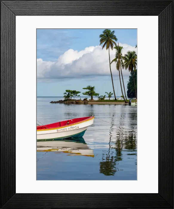 Framed Print : Traditional fishing boat moored at Marigot Bay with tall palms on the small beach in the distance Framed Print : Traditional fishing boat moored at Marigot Bay with tall palms on the small beach in the distance
