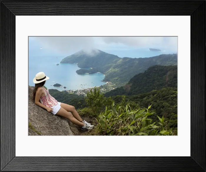 Framed Print : Young woman looking out over the Green Coast (Costa Verde) from Papapagaio peak Framed Print : Young woman looking out over the Green Coast (Costa Verde) from Papapagaio peak