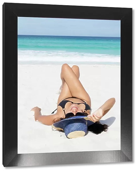Young Brazilian woman 20 to 29 years old sunbathing on a beach, Rio de Janeiro, Brazil