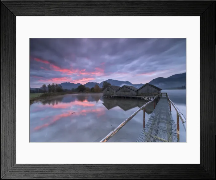 Framed Print : Purple sky at sunset and wooden huts are reflected in the clear water of Kochelsee Framed Print : Purple sky at sunset and wooden huts are reflected in the clear water of Kochelsee