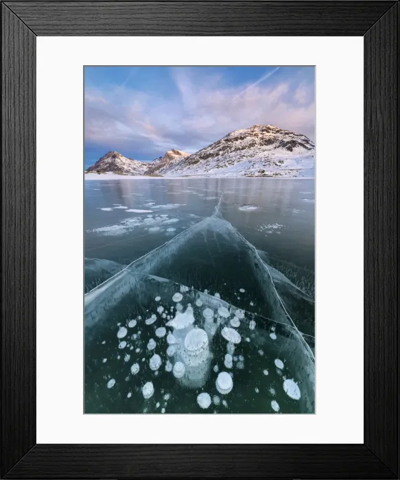 Framed Print : Ice bubbles frame the snowy peaks reflected in Lago Bianco, Bernina Pass, canton of Graubunden Framed Print : Ice bubbles frame the snowy peaks reflected in Lago Bianco, Bernina Pass, canton of Graubunden