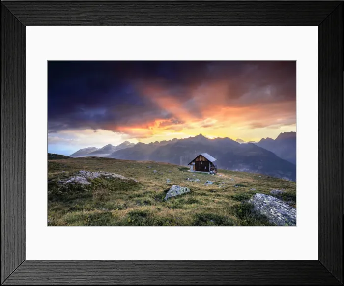 Framed Print : Wooden hut under fiery sky and clouds at sunset, Muottas Muragl, St. Moritz, Canton of Graubunden