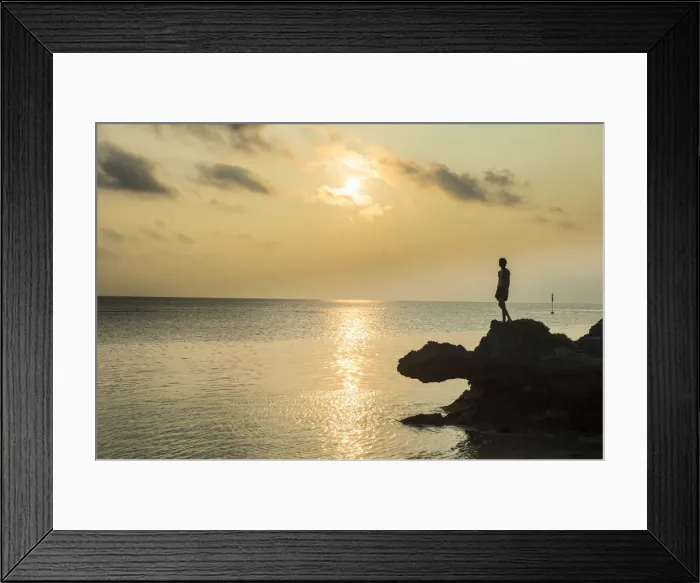 Framed Print : Man on a rock in backlight on the rocky west coast in Ouvea, Loyalty Islands, New Caledonia Framed Print : Man on a rock in backlight on the rocky west coast in Ouvea, Loyalty Islands, New Caledonia